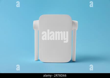 New modern Wi-Fi repeater on light blue background Stock Photo
