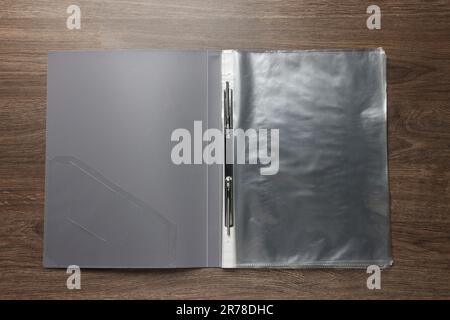File folder with punched pockets on wooden table, top view Stock Photo