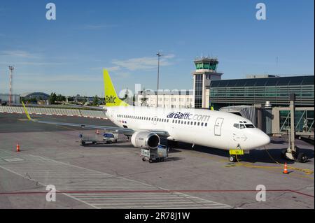 RIGA, LATVIA - JUNE 13, 2011: airBaltic Boeing 737 docked in Riga airport. June 13, 2011. AirBaltic operates about 60 direct flights from Riga. Stock Photo