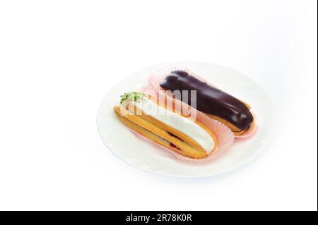 close up shot of two eclairs, isolated on white Stock Photo