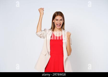 Happy young woman hands up raised arms from happiness isolated on white background. Stock Photo