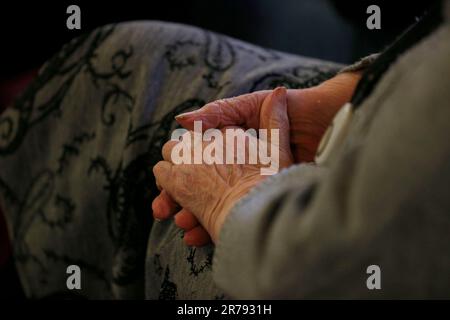 File photo dated 23/02/2014 of an elderly person at a charity tea party in London. UK scientists are working on a smell and taste test that could help screen people with Alzheimer's disease long before symptoms of memory loss. The research, led by WMG at the University of Warwick, involves using a machine that will be able to create flavours accurately. The aim is for participants to smell and drink different flavour solutions and describe them. Those who perform poorly can then be referred for further tests which could result in an Alzheimer' s diagnosis, the scientists said. Issue date: Wedn Stock Photo