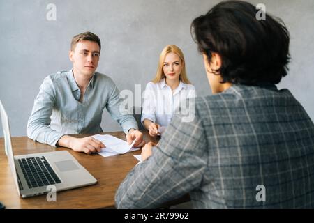 Back view of unrecognizable male applicant introducing during job interview, talking about working experience, recruiters hr managers interviewing Stock Photo