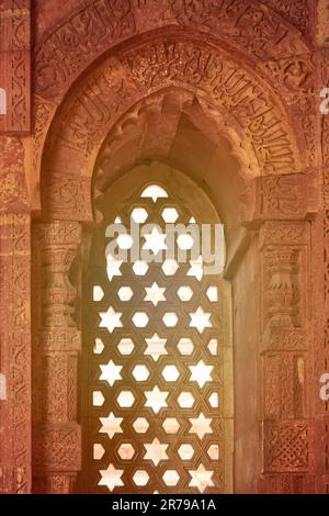 Decorative window shutters of Alai Darwaza landmark part of Qutb complex in South Delhi, India, red sandstone and inlaid white marble ancient window d Stock Photo