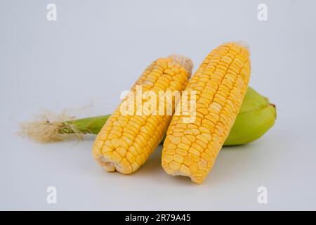 Corn on the cob with peeled corn on white background Stock Photo