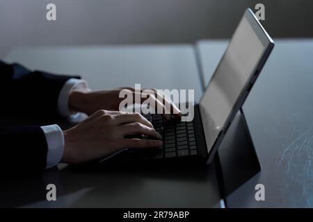 Asian businessman working on computer at night Stock Photo