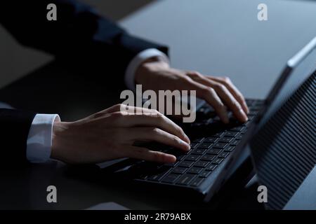 Asian businessman working on computer at night Stock Photo