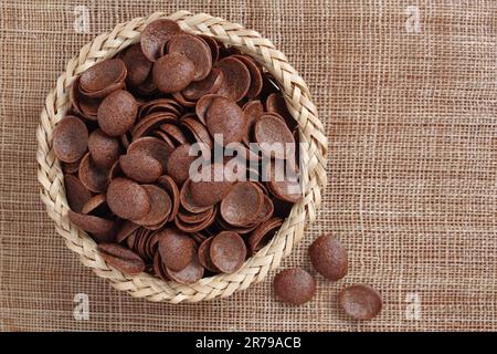 Directly above view of glazed corn flakes in wicker bowl on table close-up Stock Photo