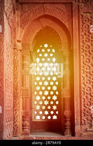 Decorative window shutters of Alai Darwaza landmark part of Qutb complex in South Delhi, India, red sandstone and inlaid white marble ancient window d Stock Photo