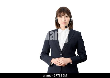 Asian telephone operator standing with headset on Stock Photo