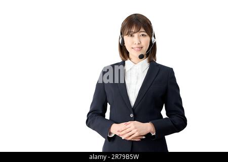 Asian telephone operator standing with headset on Stock Photo