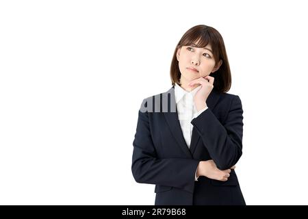 Asian business woman thinking with her hand on her chin Stock Photo