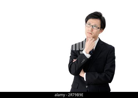 Asian business woman thinking with her hand on her chin Stock Photo