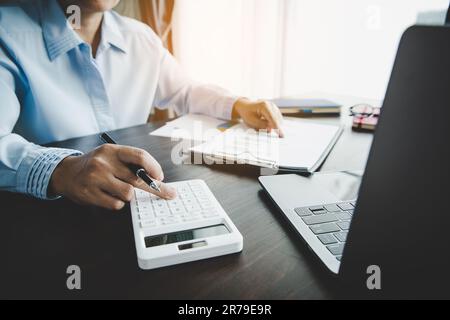 Professional businesswoman working on desk in office. Business woman hand analysis graph document financial on paperwork with chart data and marketing Stock Photo