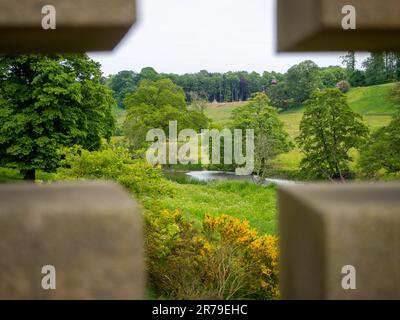 Bridge crossing the River Aln in Alnwick, Northumberland, UK, capturing the landscape of Hulne Park, The Pastures designed by Capability Brown Stock Photo