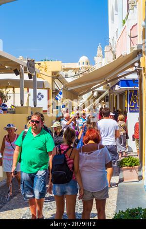 Thera,Santorini,Greece,September 7th 2013:Tourists sightseeing and admiring the picturesque  main commercial pedestrian street in Fira or Thera Stock Photo