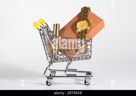A golden watch in a shopping cart at the white background. Presents, purchases Stock Photo