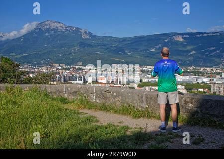 GRENOBLE, FRANCE, June 12, 2023 : Man have a look on the landscape of the city center and Vercors mountains. Stock Photo