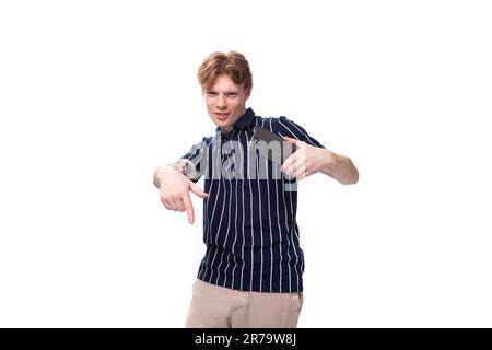 25s blond man dressed in a T-shirt with tattoos is trying to explain something Stock Photo