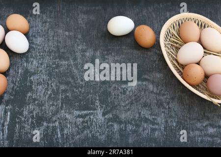 White and red brown eggs of domestic chickens in basket and Egg line on old wooden texture background. Natural eggs. Copy space, top view, flat lay Stock Photo