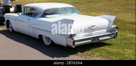 Three-quarters rear view of a White, 1958, Cadillac Eldorado Seville, on display at the 2023 Deal Classic Car Show Stock Photo