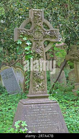 Stone crosses and grave monuments among dense greenery in Highgate Cemetery, a historic Victorian burial ground in North London, England, UK. Stock Photo