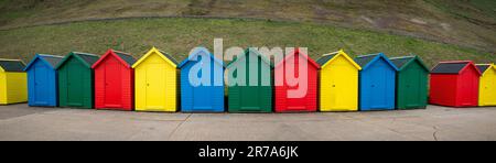 Brightly painted beach huts situated along the Cleveland Way in Whitby part of the North Yorkshire and Cleveland Heritage Coast. UK Stock Photo