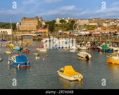 Moored boats in the Harbour of Scarborough's South Bay with the Grand Hotel in the distance. UK Stock Photo