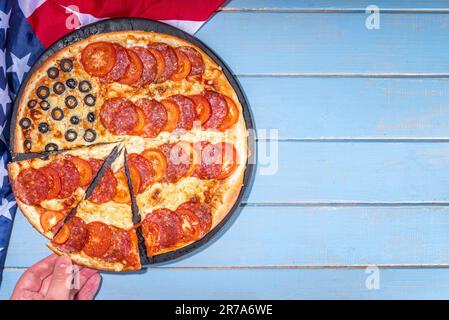 july 4th holiday party pizza, Fourth of July, Patriotic Independence day festive and picnic food. Pepperoni, tomato and black olive pizza with lot of Stock Photo