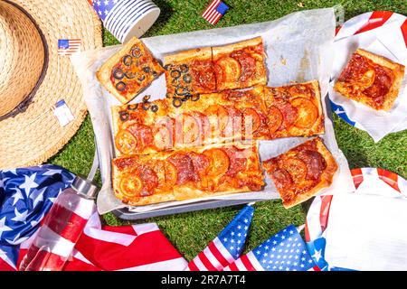 july 4th holiday party pizza, Fourth of July, Patriotic Independence day festive and picnic food. Pepperoni, tomato and black olive pizza with lot of Stock Photo