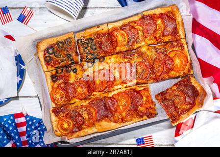 july 4th holiday party pizza, Fourth of July, Patriotic Independence day festive and picnic food. Pepperoni, tomato and black olive pizza with lot of Stock Photo