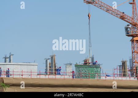 Dubai, United Arab Emirates - 14th April, 2023 : Laborers busy at work at a new construction site. Stock Photo