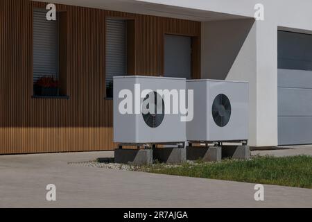 Modern house front with installed air source heat pumps. Concept of renewable energy Stock Photo