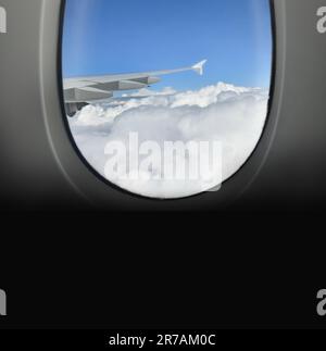 Airplane window view clouds and wing of plane,copy space Stock Photo