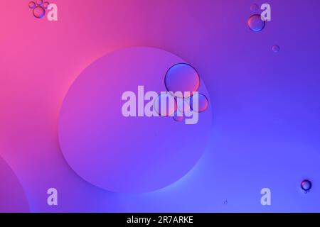 Top view movement of oil bubbles in the liquid. Oil surface multicolored background. Fantastic structure of colorful bubbles. Colorful artistic image Stock Photo
