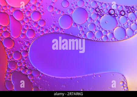 Top view movement of oil bubbles in the liquid. Oil surface multicolored background. Fantastic structure of colorful bubbles. Colorful artistic image Stock Photo