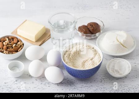 Ingredients: oatmeal flour, eggs, water, butter, curd cheese, boiled condensed milk, nut, powdered sugar, salt for healthy gluten-free baking on a Stock Photo