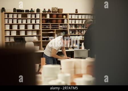 Ceramics designers workers together at a studio table Stock Photo