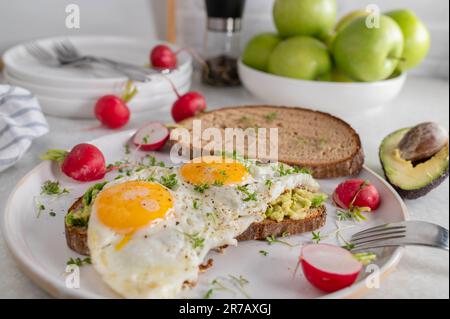 Fried egg sandwich with avocado spread Stock Photo