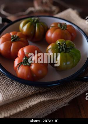 Red and green beefsteak tomatoes Stock Photo