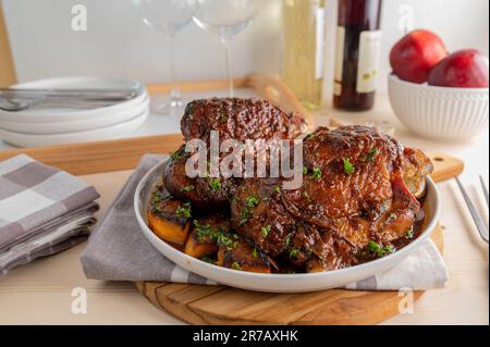 Sunday or holiday meat dish with oven roasted turkey shanks and vegetables Stock Photo