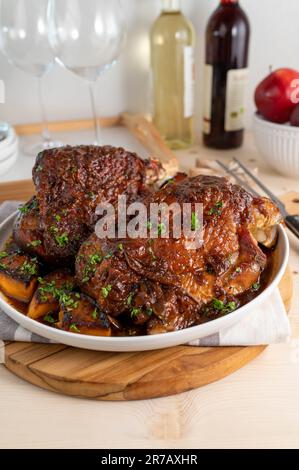 Sunday or holiday meat dish with oven roasted turkey shanks and vegetables Stock Photo