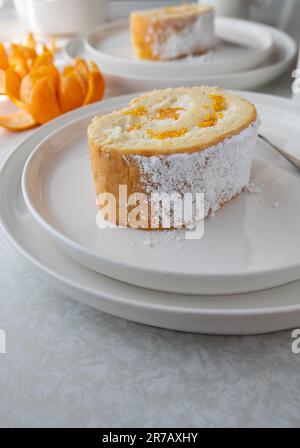 Slice of swiss roll with cream and mandarin oranges Stock Photo