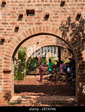 View through arches with kids in art workshop. Subteranian Ruins, Kaggalipura, Bangalore, India. Architect: A Threshold Architects, 2023. Stock Photo