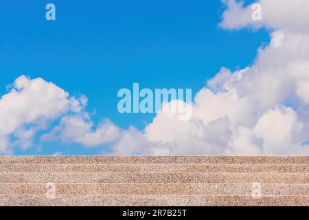 Steps to the sky. A view of the stairs, the bright sky and the clouds. The concept of striving upwards Stock Photo