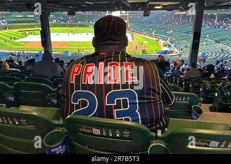 A baseball fan wears a Pride 23 Chicago Cubs jersey at Pride Night before a  baseball game between the Cubs and the Pittsburgh Pirates on Tuesday, June  13, 2023, in Chicago. (AP
