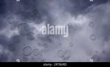 Warsaw, Poland. 11th June, 2023. Soap bubbles are flying on gray cloudy sky background (Credit Image: © Andrey Nekrasov/ZUMA Press Wire) EDITORIAL USAGE ONLY! Not for Commercial USAGE! Stock Photo