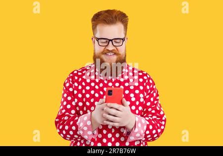 Happy fat man uses his mobile phone for online shopping, chatting and using mobile applications. Stock Photo