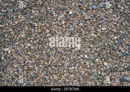 Round pebble texture background. Pebble sea beach close up, dark round pebbles and gray dry pebbles, high quality photo idea for screen Stock Photo