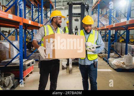 Warehouse workers checking and controlling boxes in warehouse Stock Photo